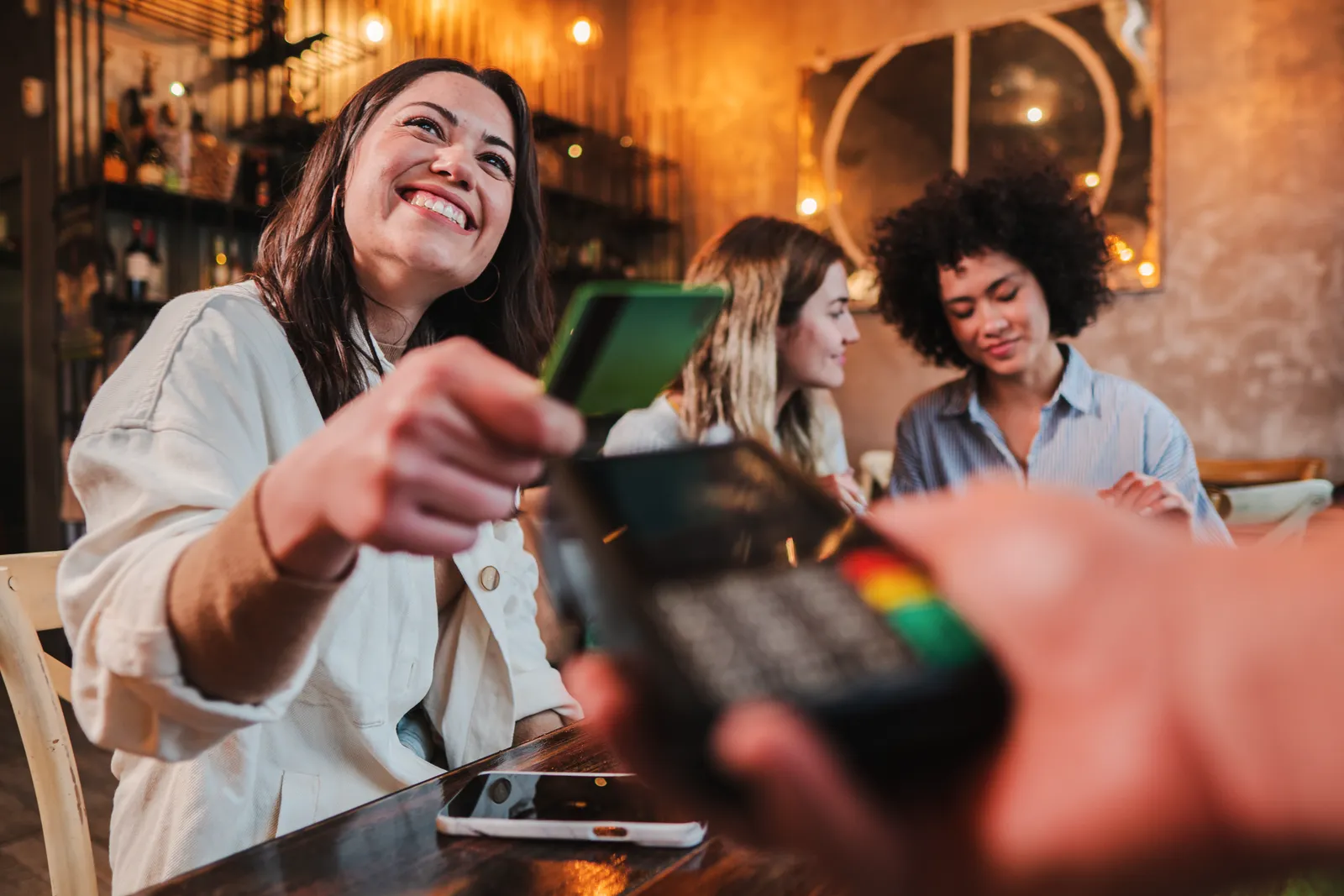 Customer paying with a card at a cafe