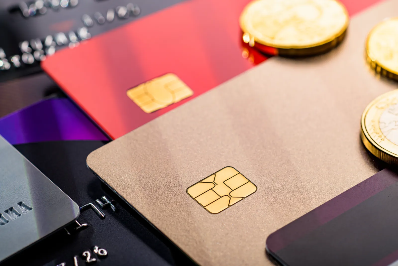 Gold coins beside payment cards